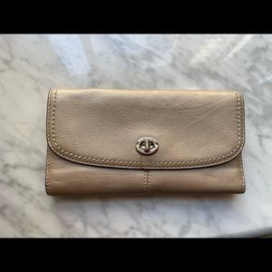 Coach wallet in a golden tan hue.